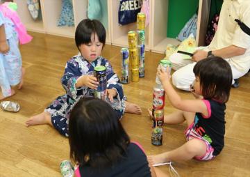子どもたちが缶積みをしている写真