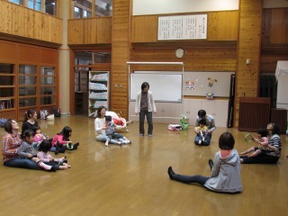 子ども達がパパやママの膝に乗ってふれ合いあそびをしている写真