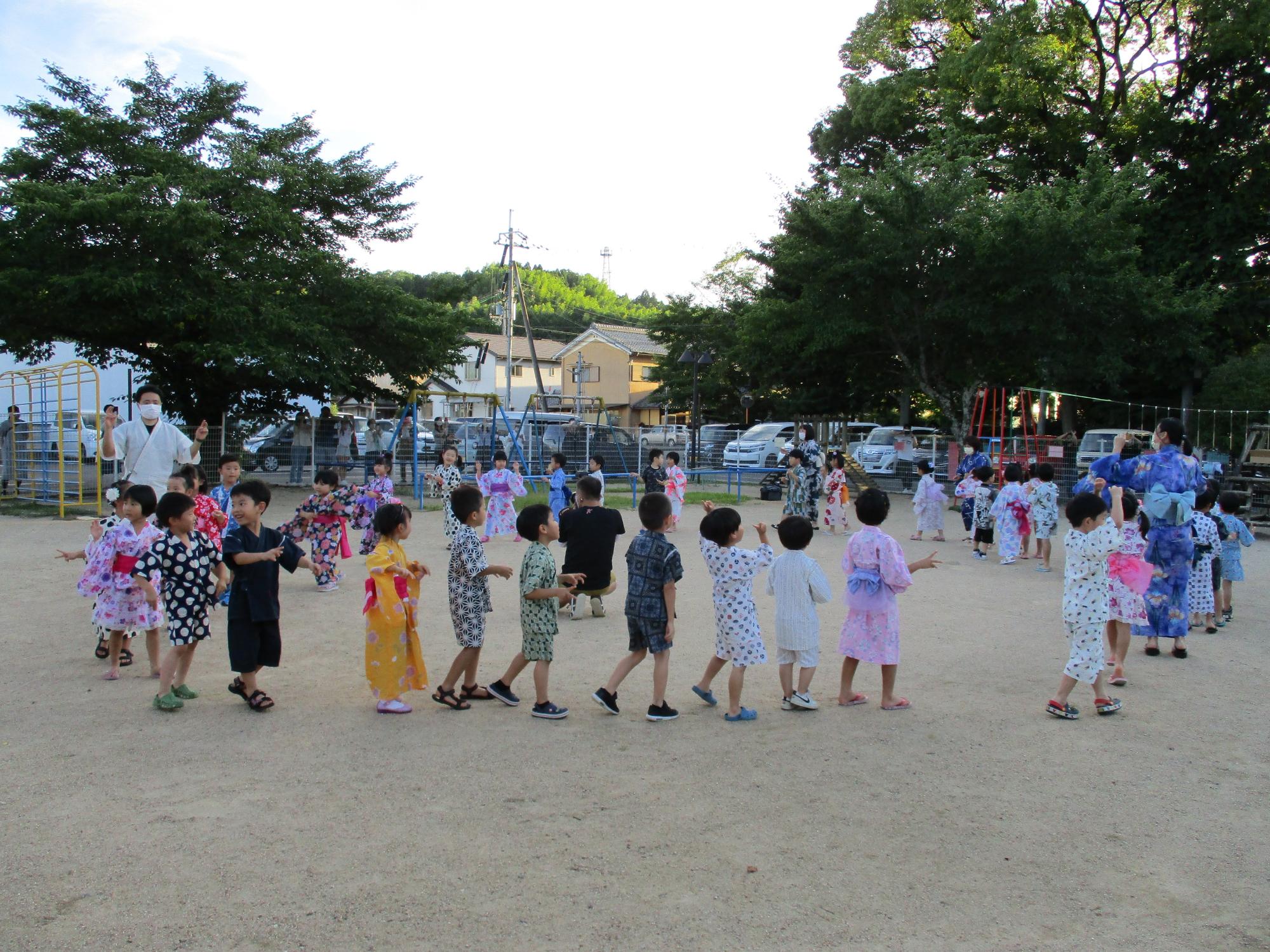 子ども達が輪になって踊っている様子の写真