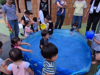 大きな青いプールに子供たちが入って遊んでいる写真